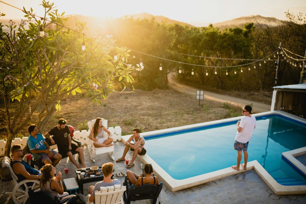 A lively poolside gathering with friends enjoying a sunny day together.