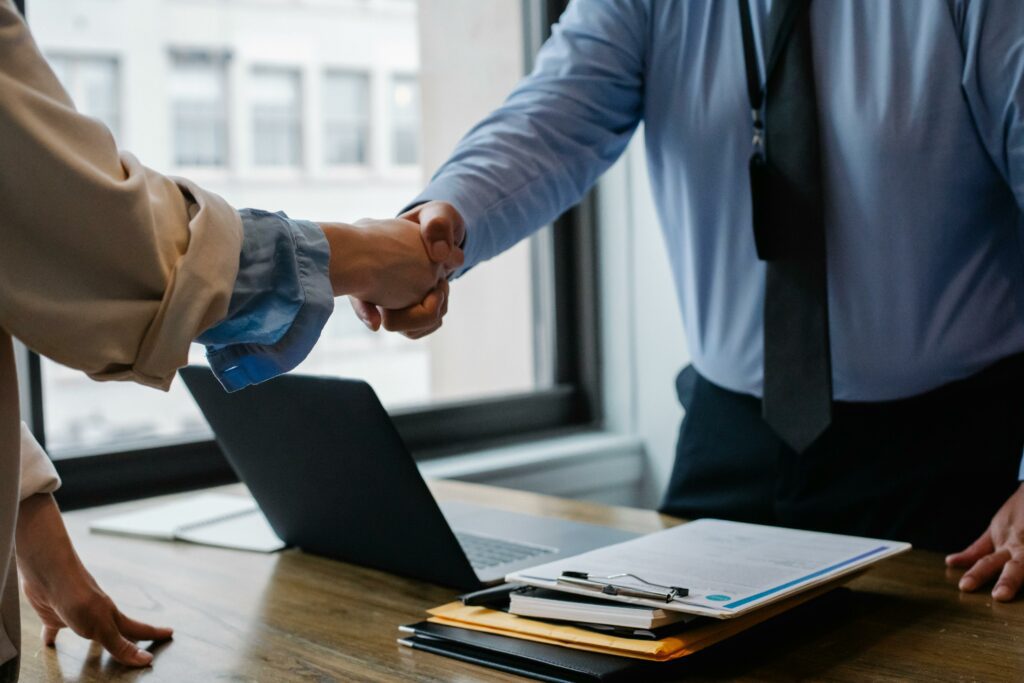 Two people shaking hands in an office