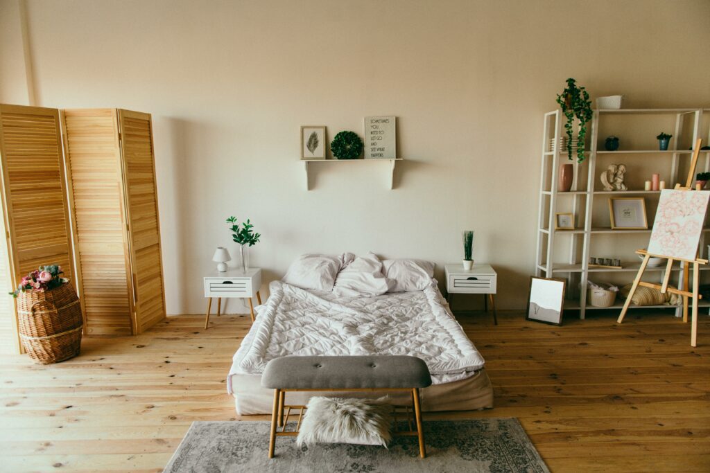 Simple bedroom setup with bed, chair, and table.